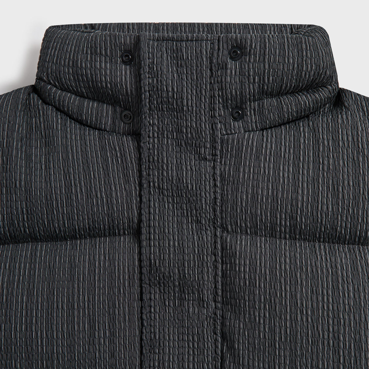 Close-up of the hood, collar and snaps on the charcoal Pleated Tech Maverick puffer