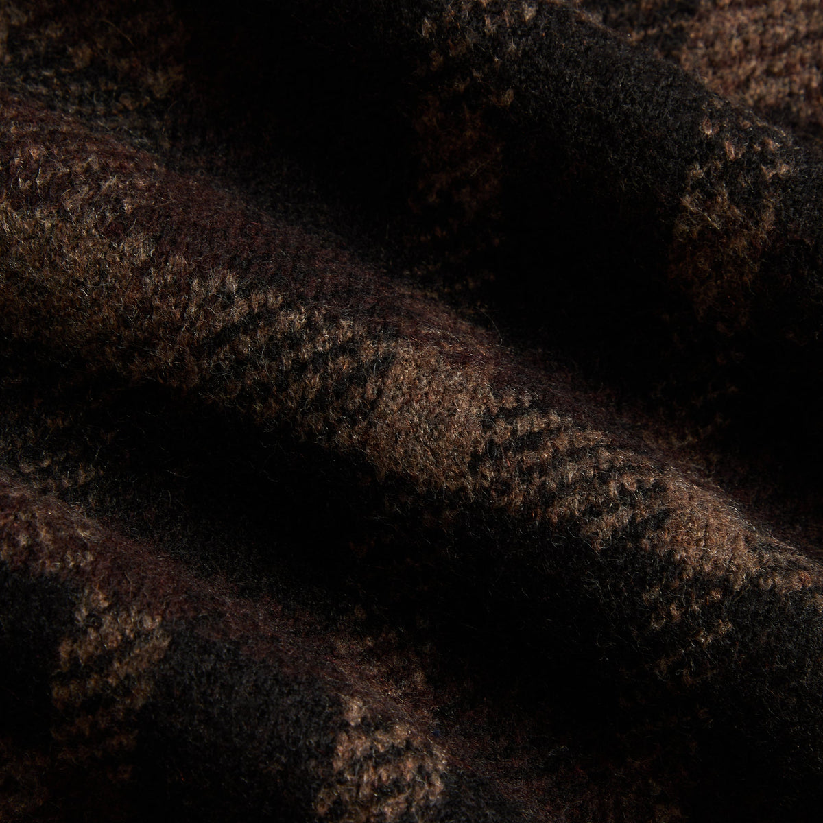 Close-up of the black and brown check knit fabric of the Kith Lewis sweater