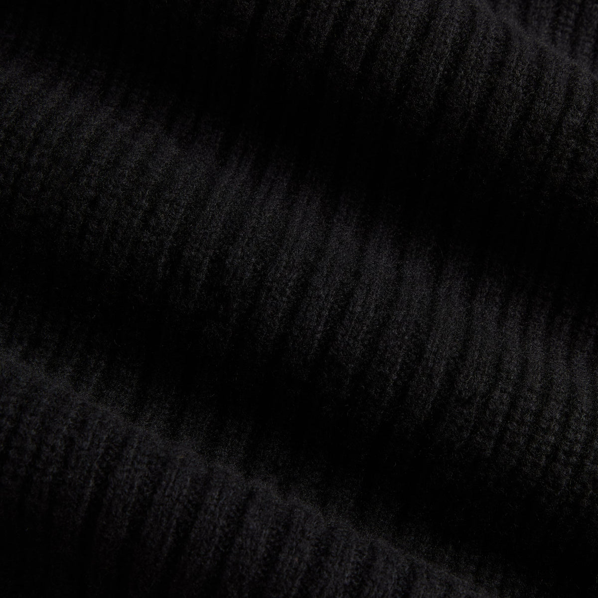 Close-up of black marled ribbed knit fabric of the Kith Copeland quarter-zip