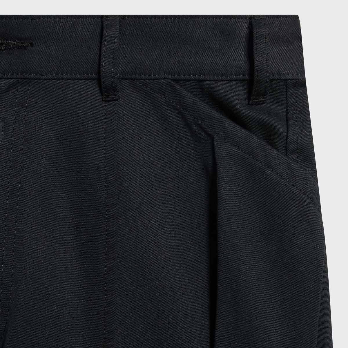 Close-up of the belt loops and front pleat on the black Gus cargo pant