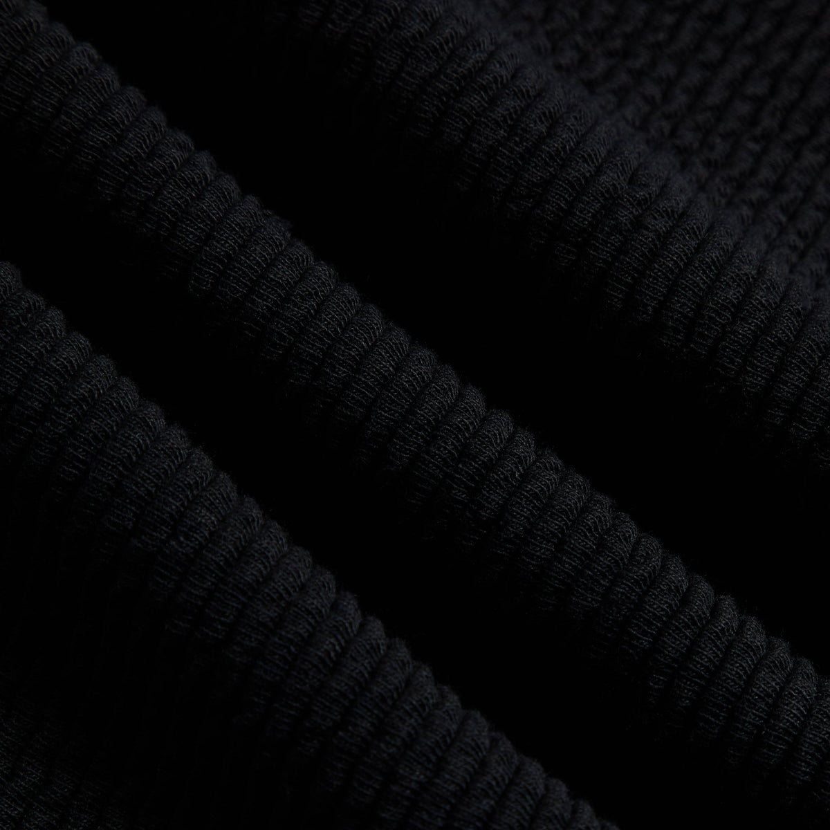 Close-up of black heavy crepe fabric of the Kith Elmhurst pant