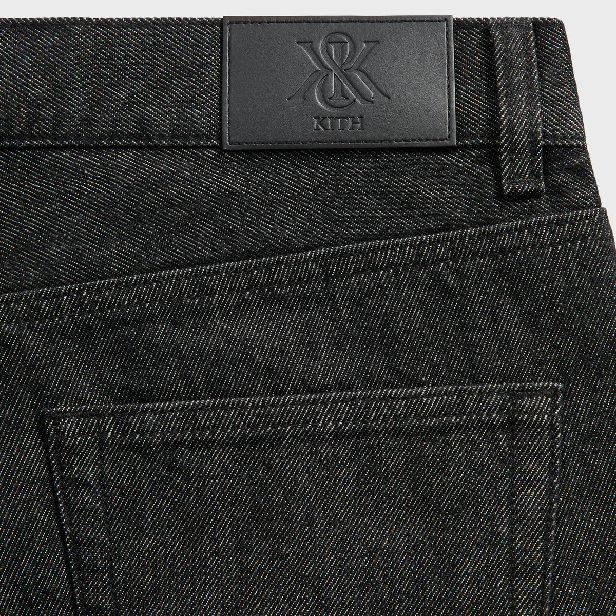 Close-up of the black leather Kith patch on the waistband of the Webster Chill jeans