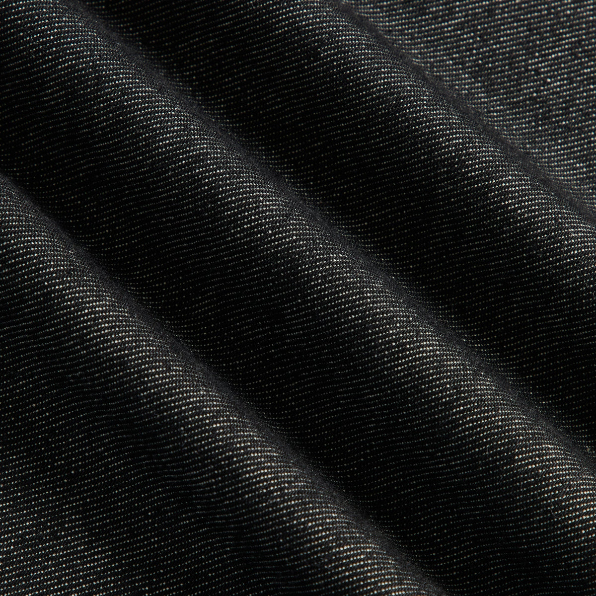 Close-up of washed black denim fabric of the Kith Webster Chill jeans